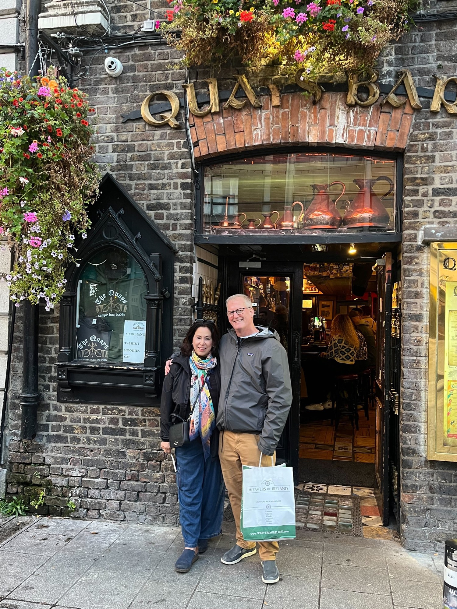 Two travelers outside a flower-covered pub in Temple Bar, Dublin.