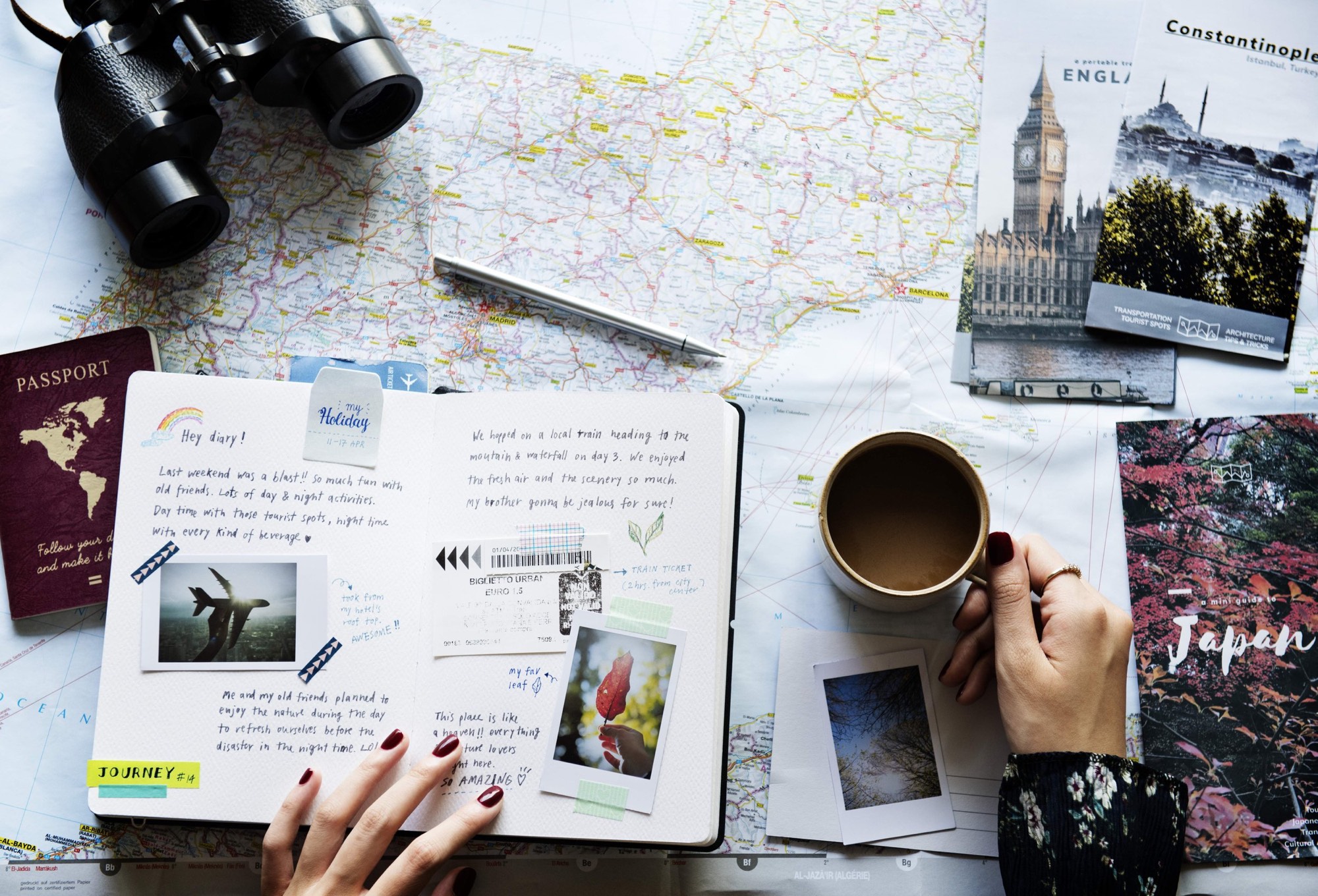 A travel planning scene with a map, postcards and a notebook.